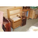 An open fronted bookcase together with a piano sto