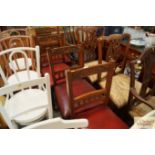 A set of four late Victorian carved oak dining cha