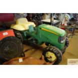 A pedal John Deere tractor