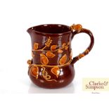 A Studio Pottery brown glazed jug, the handle surm