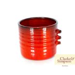 A Hecken red glazed pottery vase, having stylised