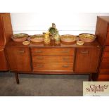 A teak G-plan sideboard fitted three central drawe