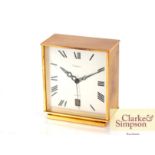 A Cartier circa 1960's brass cased battery powered desk clock with date aperture, 9cm x 10cm