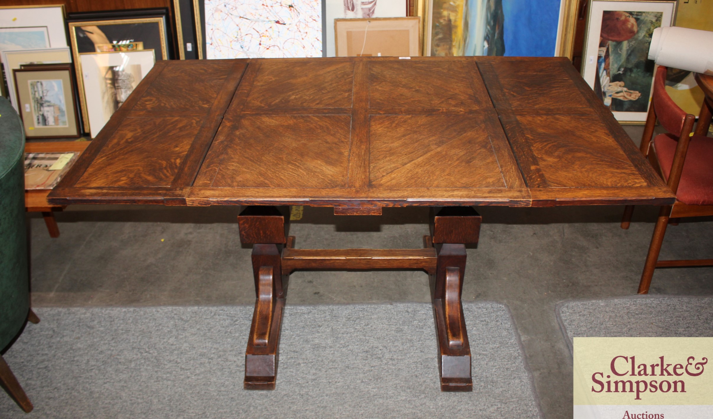 A 1930's oak draw leaf dining table, extending to