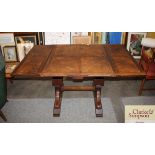 A 1930's oak draw leaf dining table, extending to