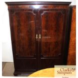 A mahogany compactum type wardwobe by Waring & Gil