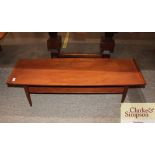 A mid-20th Century teak oblong coffee table, raise