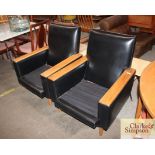 A pair of 1960's black vinyl armchairs