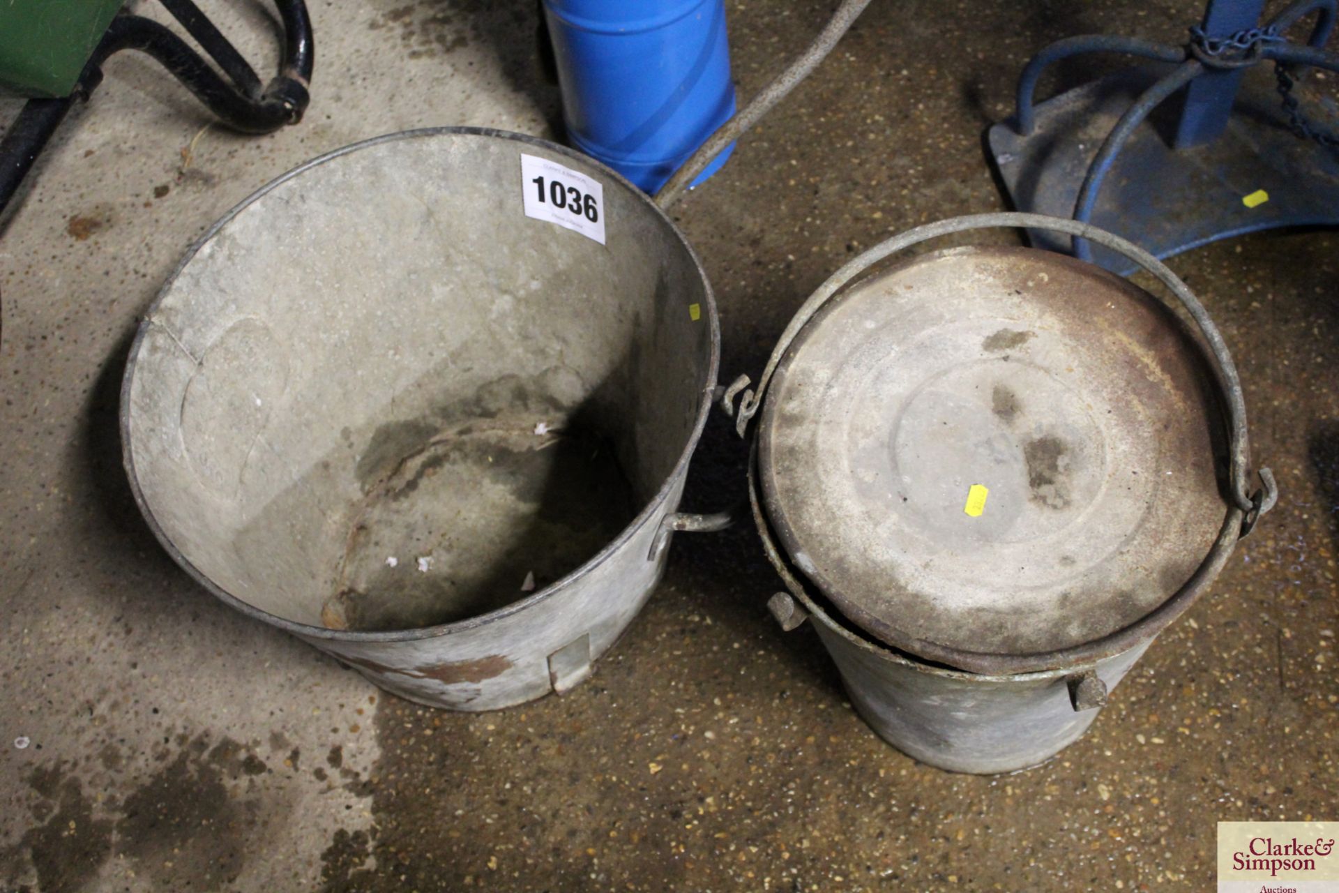 Galvanised feed hod and pail of grease.