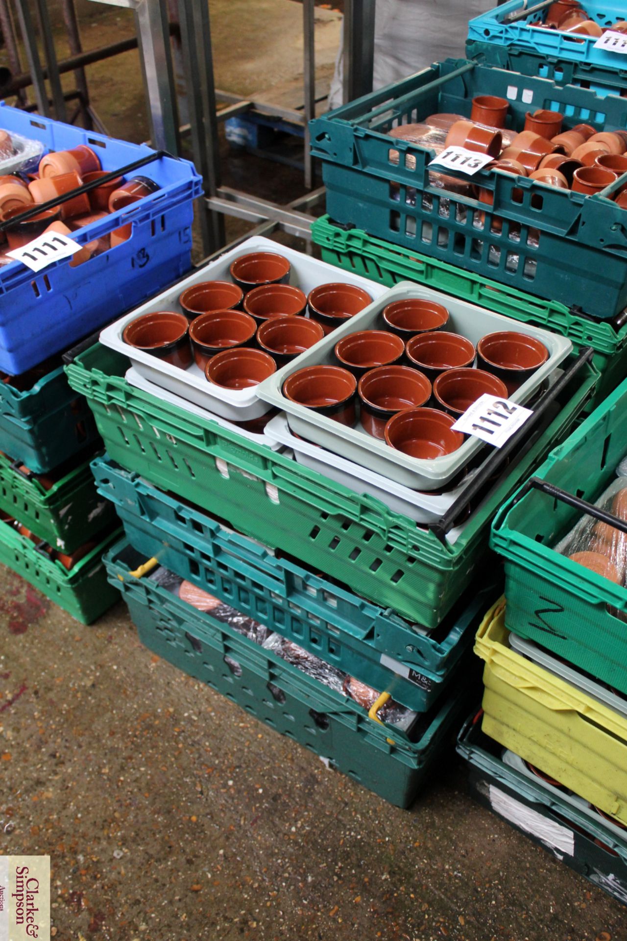 Three crates of modern terracotta ramekins/ pots.