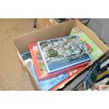 A box of miscellaneous jigsaw puzzles