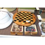 An inlaid wooden circular chess board and gilt and