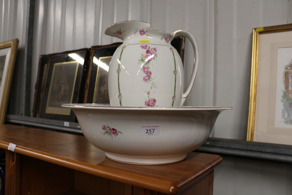 A rose decorated toilet jug and basin