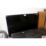 A Toshiba flat screen television with remote contr