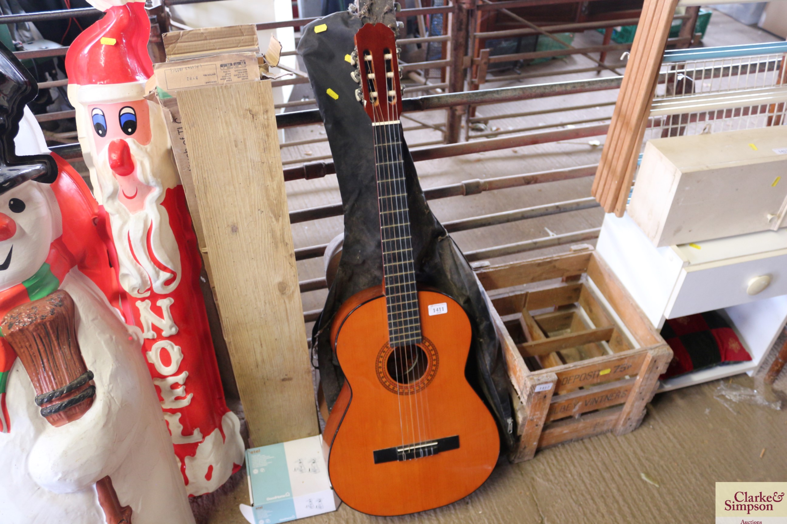 An acoustic guitar with carrying bag and a further