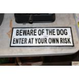 A cast iron "Beware Of The Dog - Enter At Your Owe