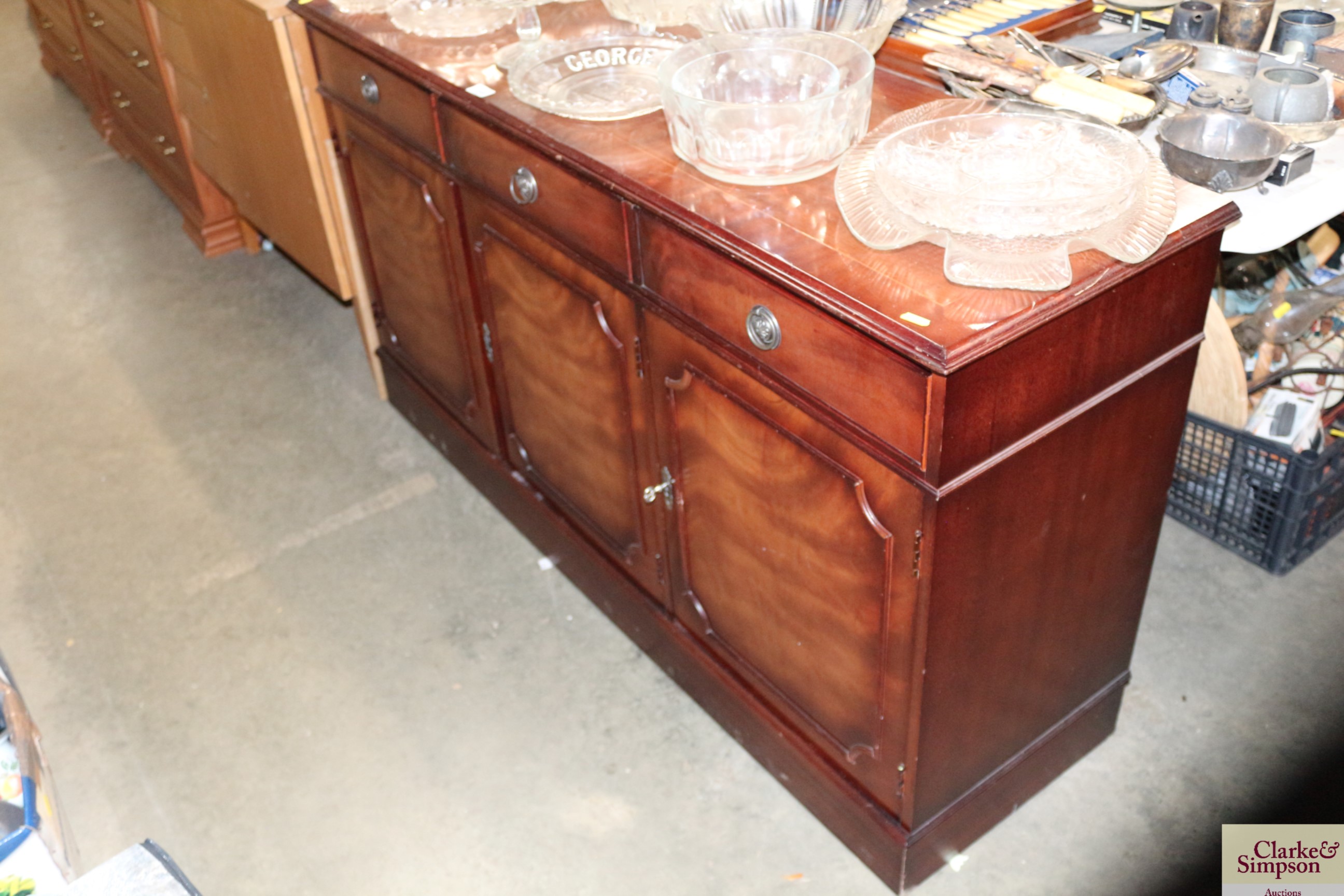 A reproduction mahogany sideboard fitted three dra