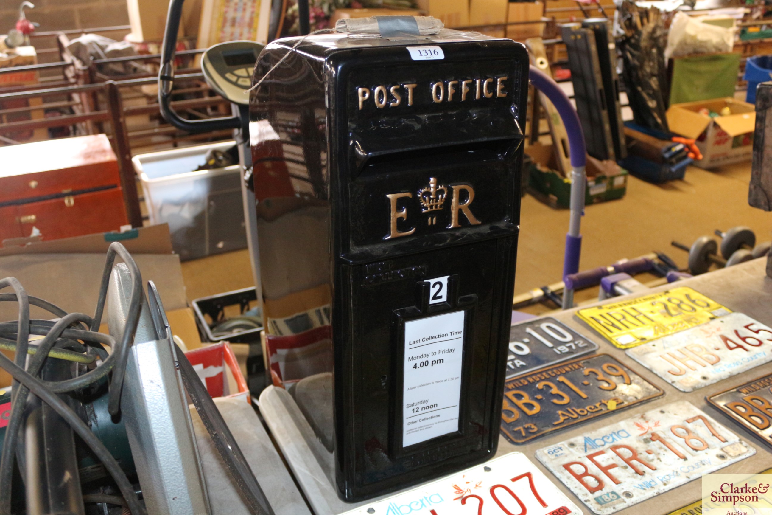 A reproduction ER black painted metal post box wit