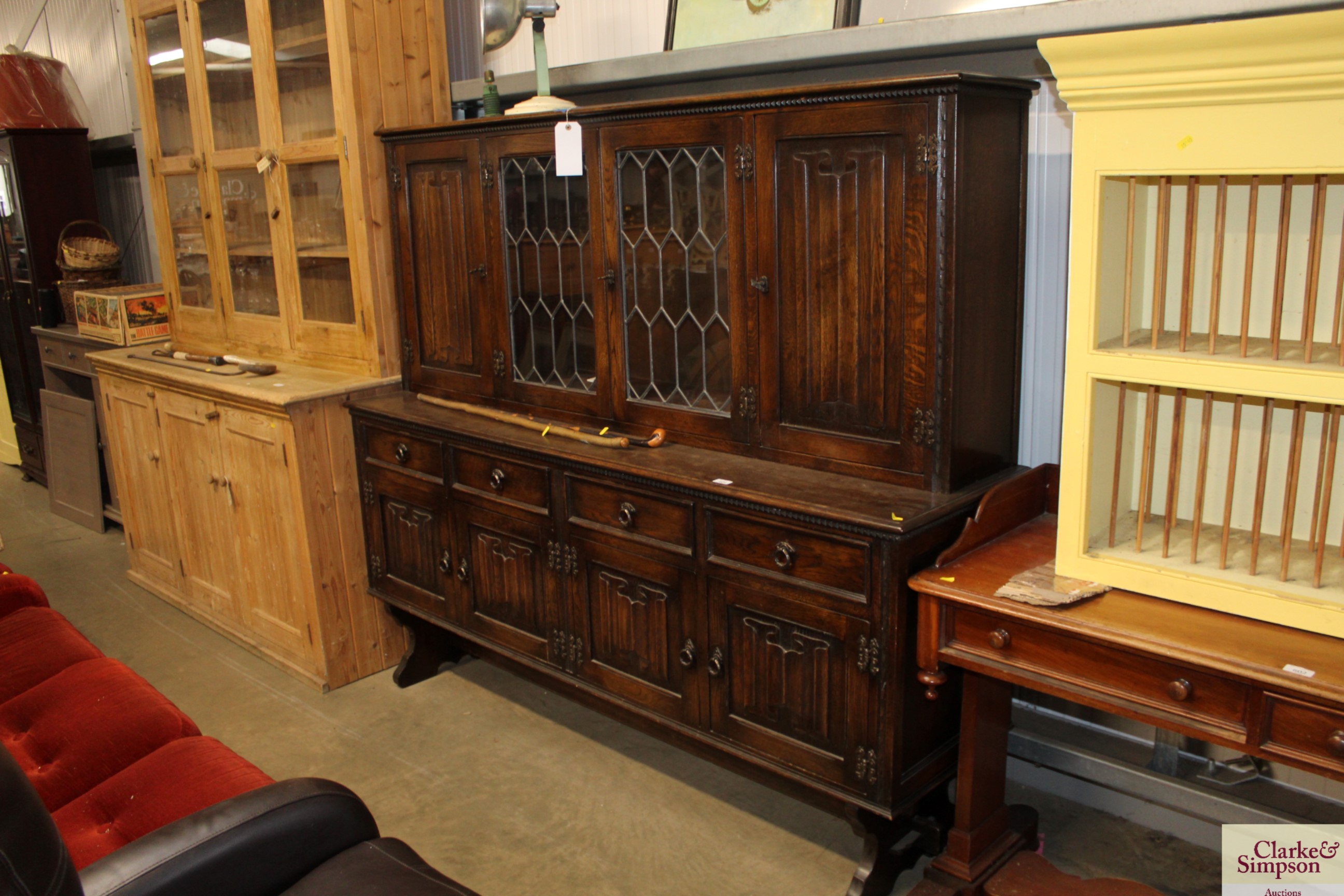 An oak linen fold decorated and leaded glazed sideboard