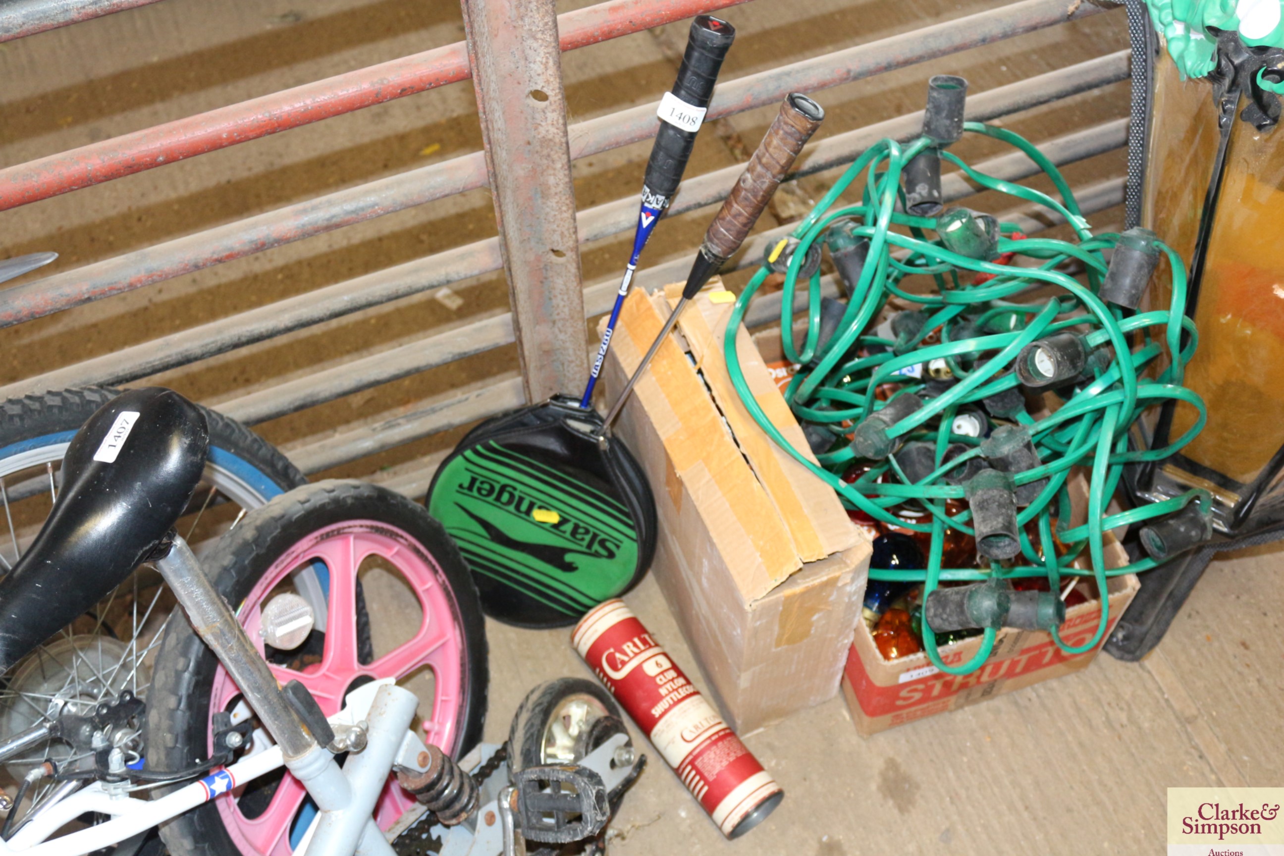 Two badminton rackets and a tube of shuttlecocks