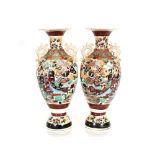 A pair of large Japanese baluster vases, having brightly coloured floral and figure decoration,