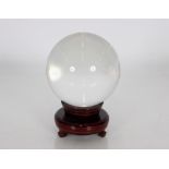 A crystal ball on wooden stand