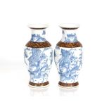 A pair of Chinese blue and white baluster vases decorated warriors and other figures, 32cm high