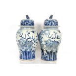 A large pair of Chinese blue and white baluster vases, the covers surmounted by Kylin finials, the