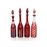 Four Victorian ruby glass and overlaid decanters