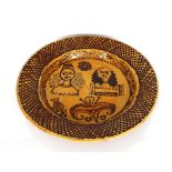 A large circular Staffordshire slipware dish, decorated with King and Queen, circa 1850 AF, 61cm
