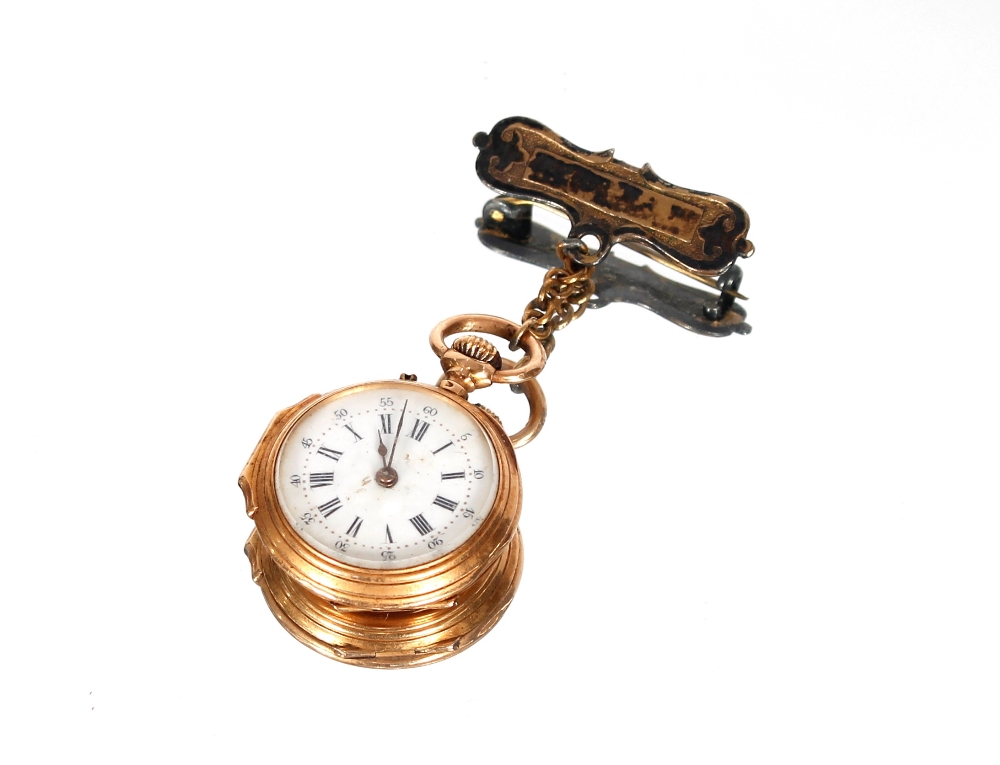 A small metal fob watch; a small gold fob watch with white enamel dial; a perfume bottle and a