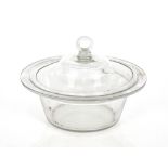 An antique glass bowl and cover, the domed lid with coiled handle, 28cm dia. x 18cm high