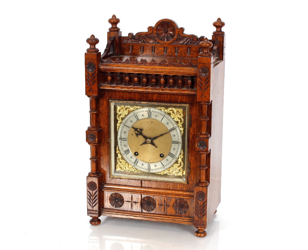 A late Victorian oak cased bracket clock, the eight day movement striking the hours and the quarters