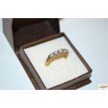 A 9ct gold ring set six white stones