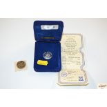 A Pobjoy Mint Isle of Man £1 coin (cased) and another coin