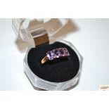 A 9ct rose gold four stone amethyst ring