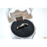 A 9ct gold ring set with two square diamonds