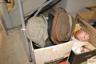 A box containing various vintage hats etc.