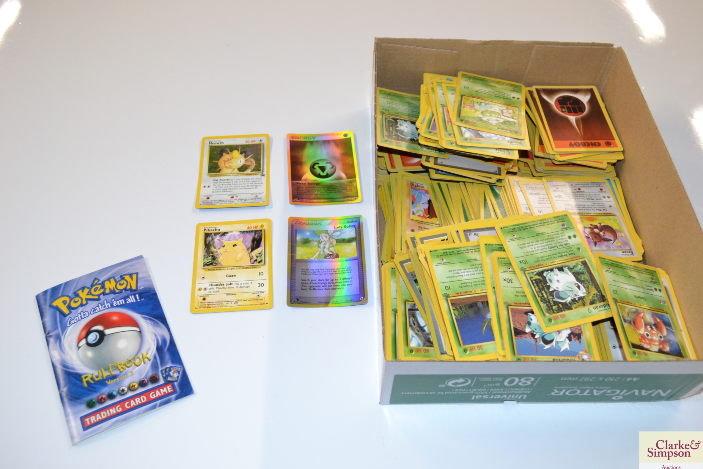 A box of Pokémon cards including Rule Book Version