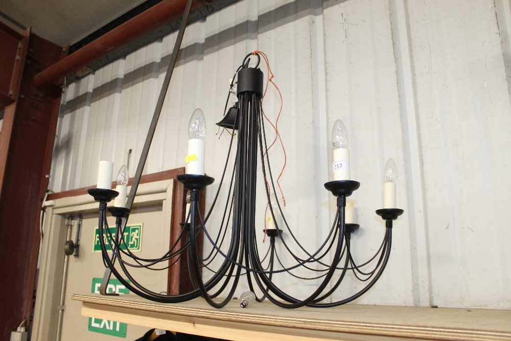 A wrought metal eight light pendant light fitting