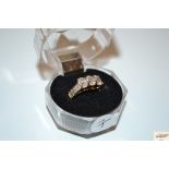 A 9ct gold ring set with three smoky stones and di