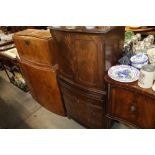 A mahogany bow fronted cocktail cabinet