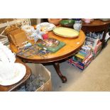 A circular Victorian mahogany snap top dining table