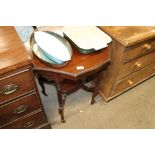 An Edwardian mahogany window table with shaped top