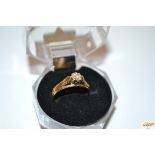 A 9ct gold ring set with solitaire diamond within