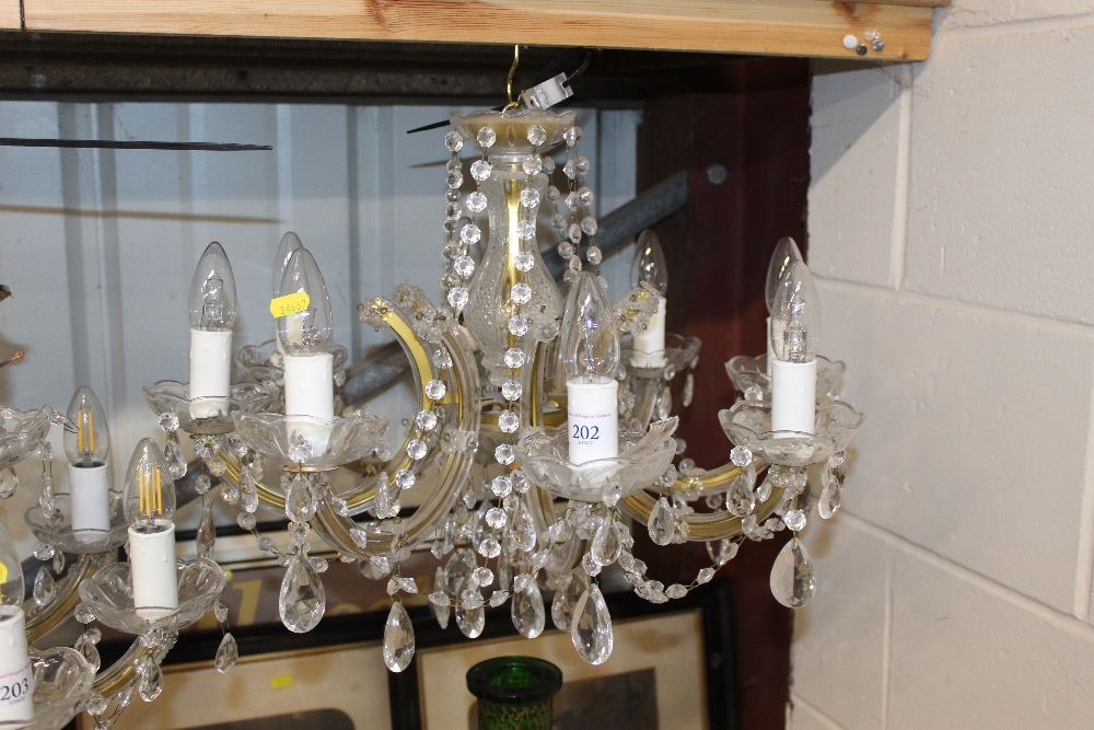 A glass and gilt eight light chandelier