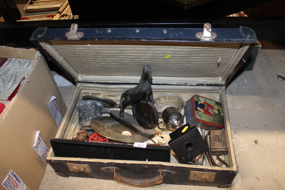 A suitcase and contents including a model of a Whi