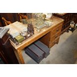 A 1920's grained pine kneehole desk