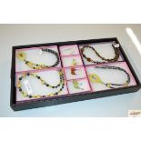 A tray containing various handmade jewellery; semi