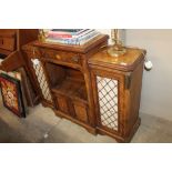 A walnut and inlaid small break front side cabinet